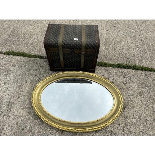 271 - A modern trunk together with an oval mirror