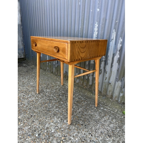 1 - An ercol light elm single drawer writing desk 49x64 x74