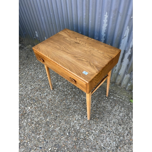 1 - An ercol light elm single drawer writing desk 49x64 x74