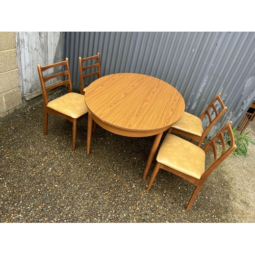 107 - A mid century teak table and four chairs by Schreiber