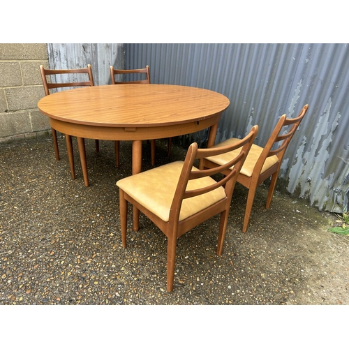 107 - A mid century teak table and four chairs by Schreiber