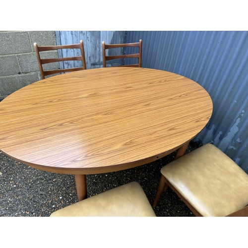 107 - A mid century teak table and four chairs by Schreiber