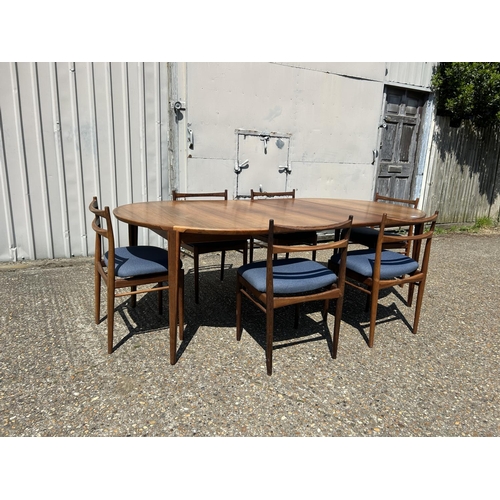 11 - A danish rosewood extending dining table by ROSENGREN HANSEN together with a set of six matching ros... 