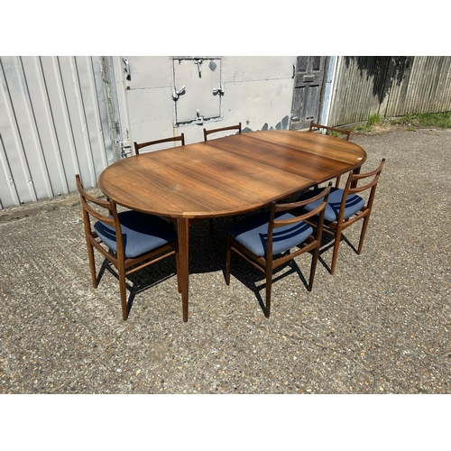 11 - A danish rosewood extending dining table by ROSENGREN HANSEN together with a set of six matching ros... 