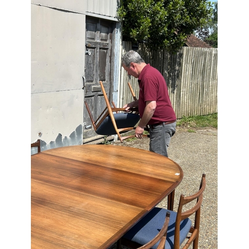 11 - A danish rosewood extending dining table by ROSENGREN HANSEN together with a set of six matching ros... 