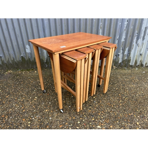 111 - A mid century teak nest of five tables