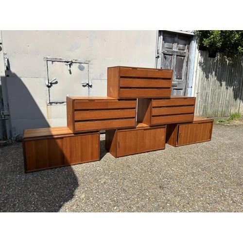 12 - A collection of mid century danish teak (unmarked) wall mounting units, consisting of three four dra... 