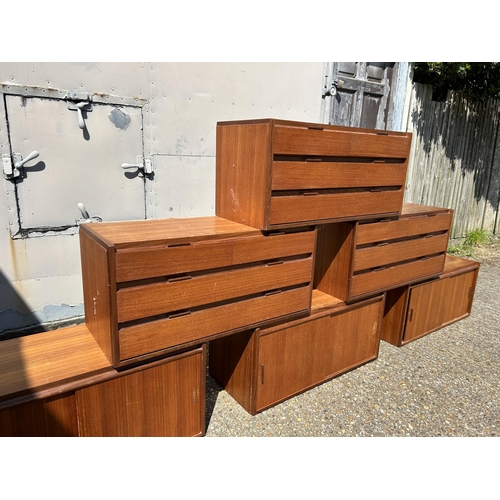 12 - A collection of mid century danish teak (unmarked) wall mounting units, consisting of three four dra... 