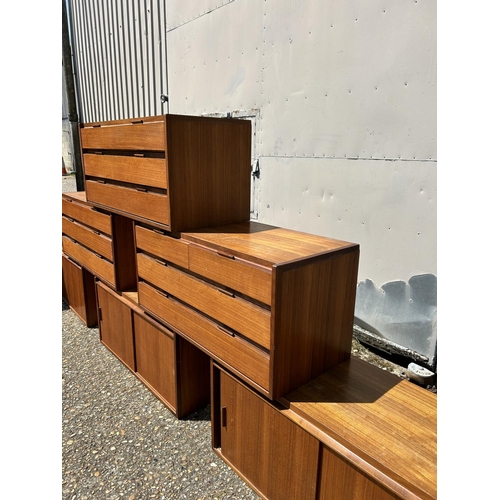 12 - A collection of mid century danish teak (unmarked) wall mounting units, consisting of three four dra... 