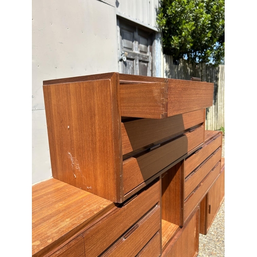 12 - A collection of mid century danish teak (unmarked) wall mounting units, consisting of three four dra... 