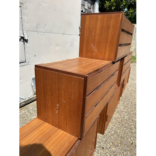 12 - A collection of mid century danish teak (unmarked) wall mounting units, consisting of three four dra... 