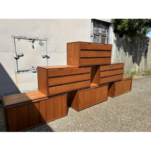 12 - A collection of mid century danish teak (unmarked) wall mounting units, consisting of three four dra... 