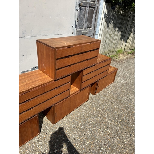 12 - A collection of mid century danish teak (unmarked) wall mounting units, consisting of three four dra... 