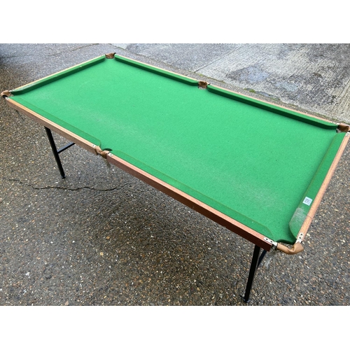 128 - A folding snooker table with balls and score board 190x98