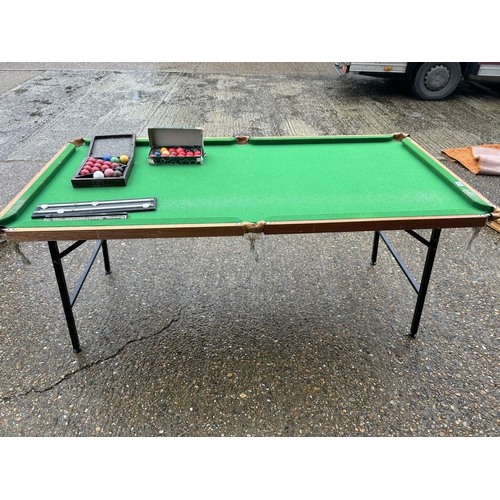 128 - A folding snooker table with balls and score board 190x98