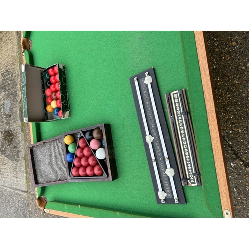 128 - A folding snooker table with balls and score board 190x98