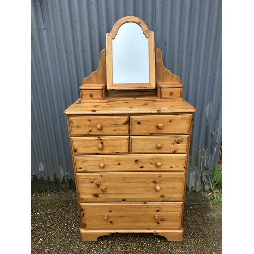 133 - A ducal pine chest of seven drawers together  with matching ducal pine swing mirror