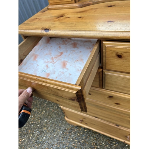 133 - A ducal pine chest of seven drawers together  with matching ducal pine swing mirror