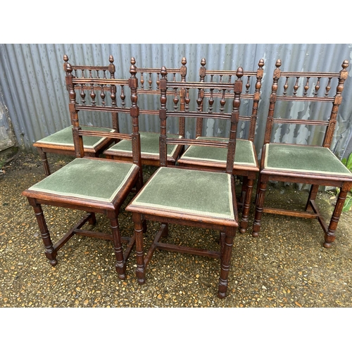 136 - A set of six oak dining chairs with green upholstered seats