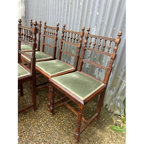 136 - A set of six oak dining chairs with green upholstered seats