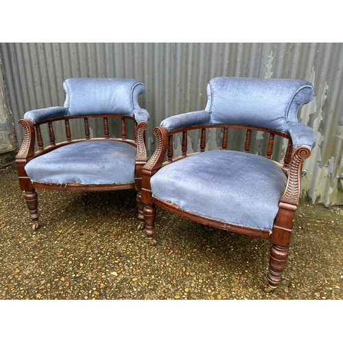 147 - A pair of Edwardian blue upholstered tub shaped salon chairs