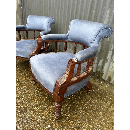 147 - A pair of Edwardian blue upholstered tub shaped salon chairs