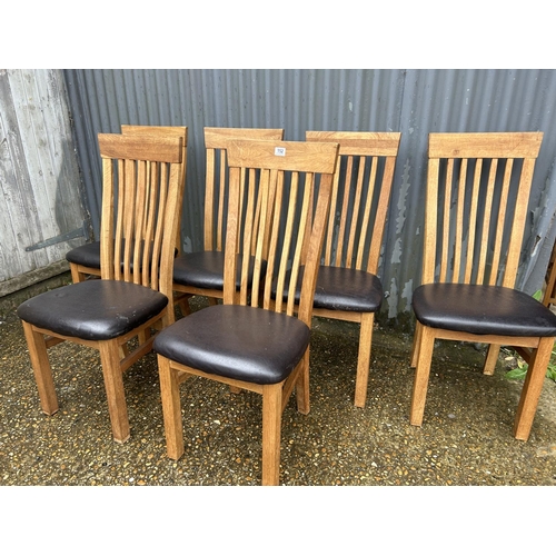 152 - A set of six modern light oak chairs with high chairs and brown faux leather seats