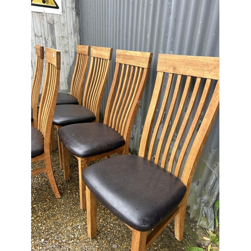 152 - A set of six modern light oak chairs with high chairs and brown faux leather seats