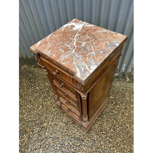 153 - A French oak marble top bedside chest of six drawers