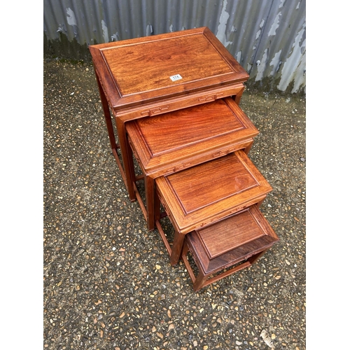 174 - AN oriental hardwood nest of four tables