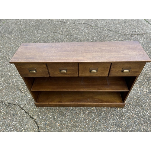 183 - A modern oak hall bookcase with four drawers 130x35x85