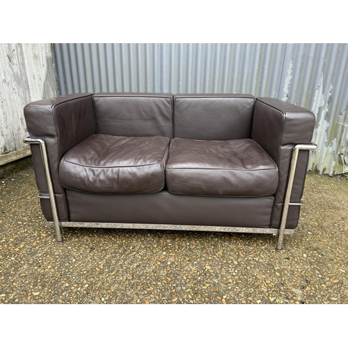 188 - A chrome framed designer sofa in the style of Le corbussier LC2 125x66x86