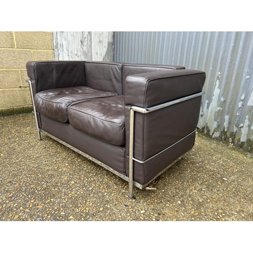 188 - A chrome framed designer sofa in the style of Le corbussier LC2 125x66x86