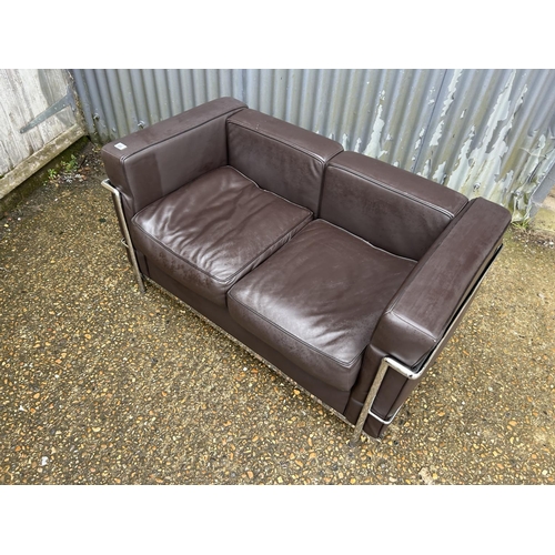 189 - A chrome framed designer sofa in the style of Le corbussier LC2 125x66x87