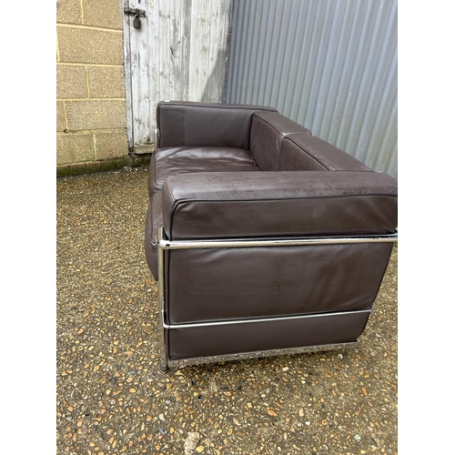 189 - A chrome framed designer sofa in the style of Le corbussier LC2 125x66x87