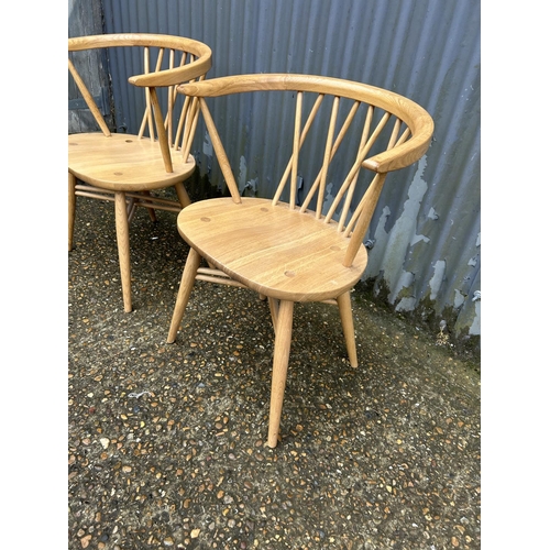 192 - A pair of modern ercol bow back carver chairs