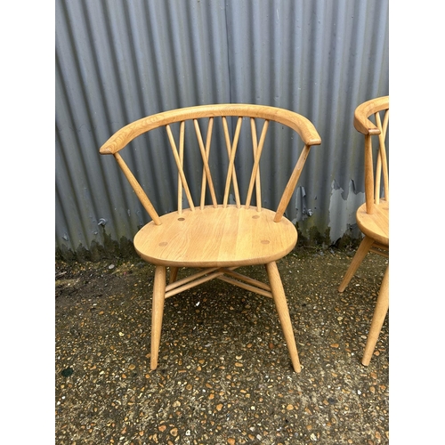 192 - A pair of modern ercol bow back carver chairs