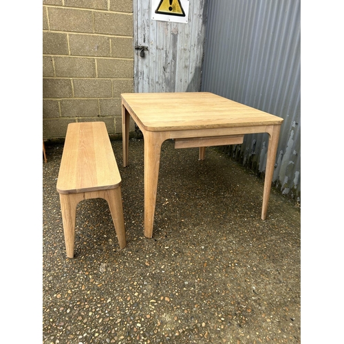 195 - A modern light oak extending dining  table from John Lewis together with matching bench 120x90x75