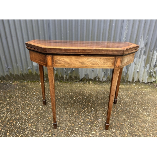 211 - A Victorian inlaid fold over card table with green baize top