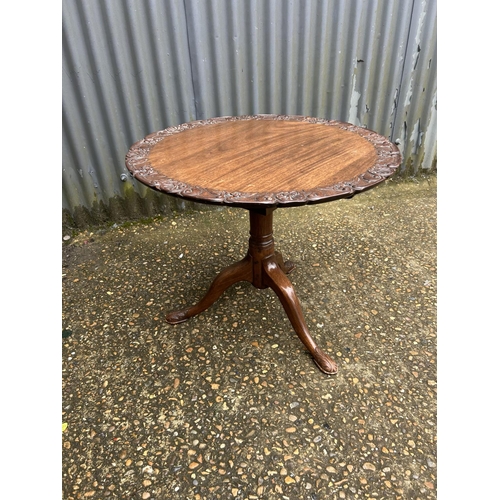 212 - An ornate carved mahogany occasional  table 66 diameter x 50 high