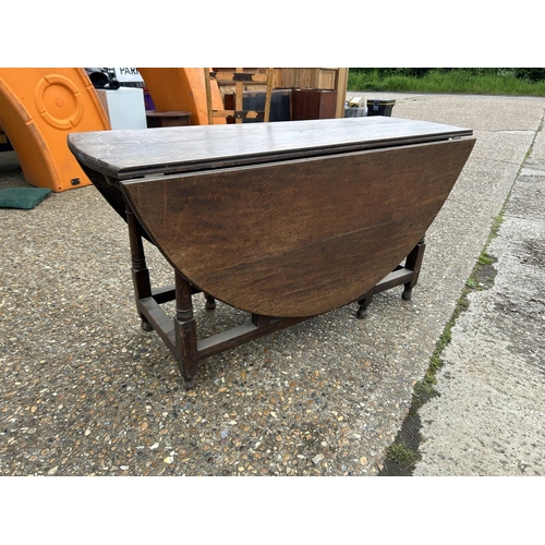 222 - A large antique oak gateleg table with drawer