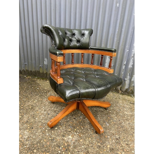 230 - A green leather chesterfield swivel captains chair