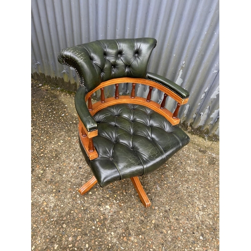 230 - A green leather chesterfield swivel captains chair