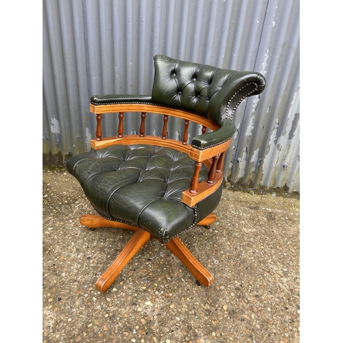 230 - A green leather chesterfield swivel captains chair