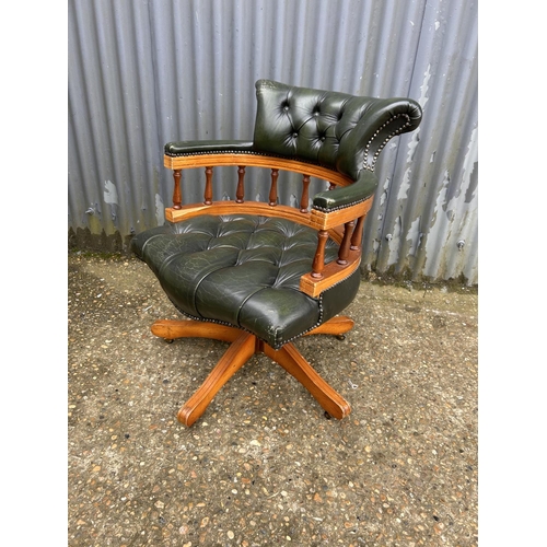 230 - A green leather chesterfield swivel captains chair