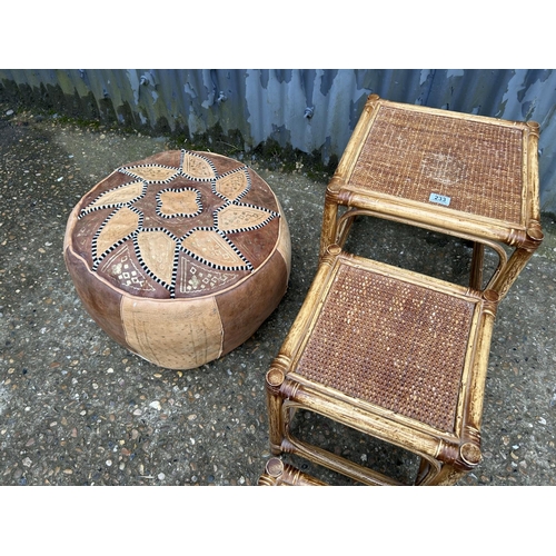 233 - A retro bamboo nest of three tables together with a leather footstool