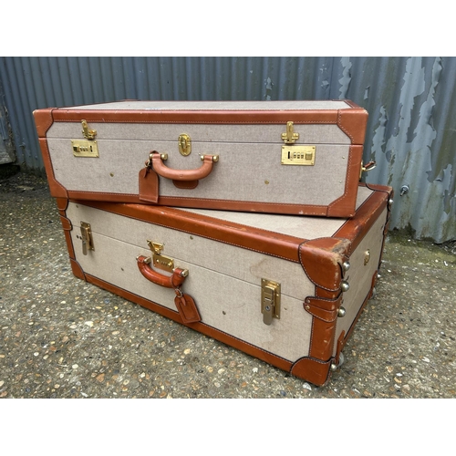 234 - A large and small pair of vintage suitcases