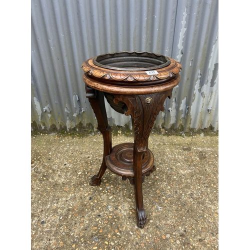 236 - A carved mahogany plant stand with brass liner