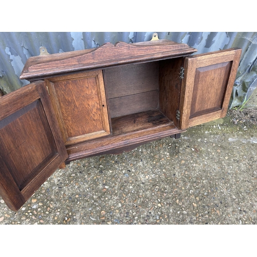 237 - An oak wall cabinet together with a Edwardian towel rail