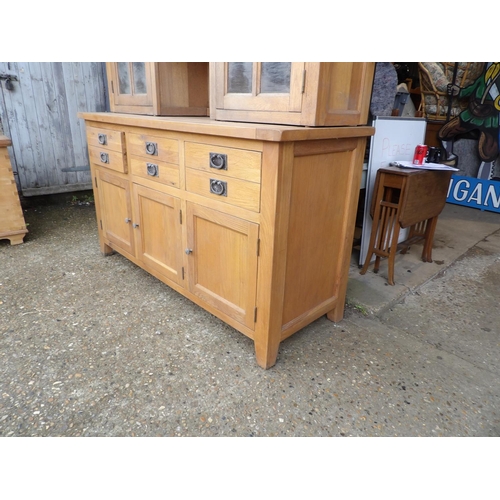 254 - A large light oak dresser with glazed top over six drawer and cupboard door base 160x60x204